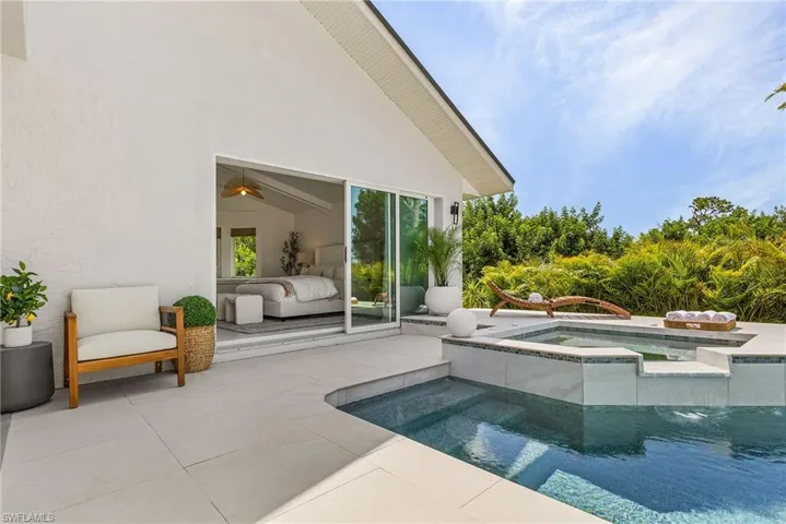View of swimming pool featuring ceiling fan, outdoor lounge area, an in ground hot tub, and a patio area