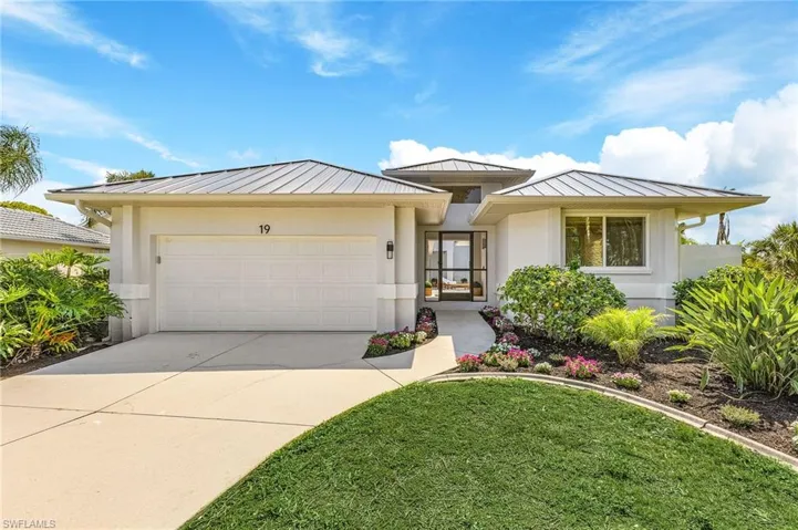 View of front of house with a garage and a front yard