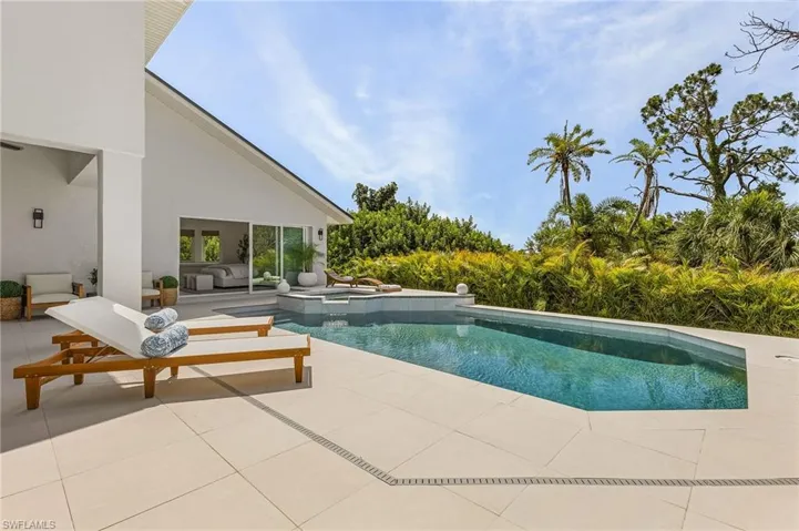 View of pool with a patio and an outdoor hangout area