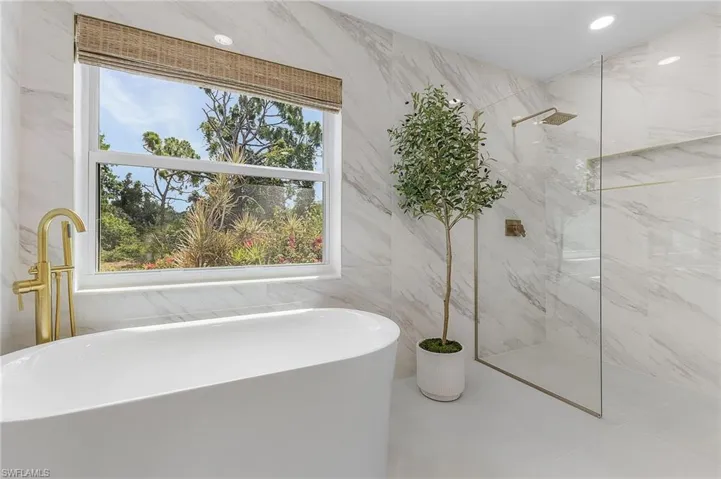 Bathroom featuring tile walls, tile flooring, and independent shower and bath