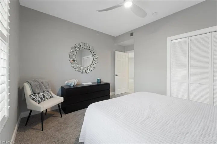 Bedroom featuring carpet, ceiling fan, and a closet