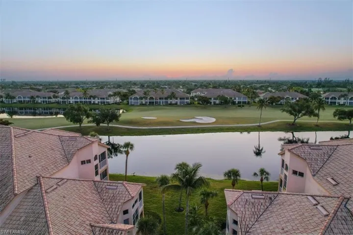 Aerial view at dusk of a water view and golf course view