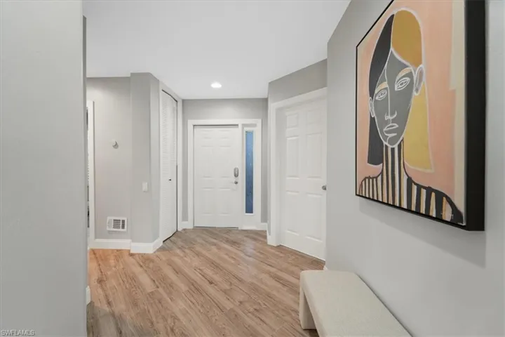 Corridor featuring light wood finished floors and recessed lighting