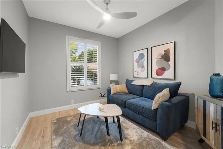 Living room featuring light wood-type flooring and ceiling fan