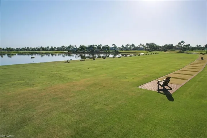 View of community with a water view and a lawn