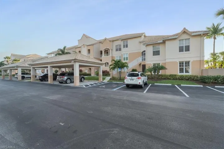 Partially covered parking lot featuring stairway and a residential view