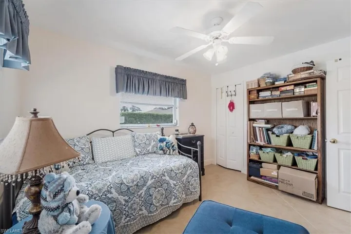 Bedroom with a ceiling fan and tile patterned flooring