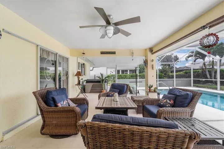 View of patio featuring an outdoor living space, a ceiling fan, an outdoor pool, and glass enclosure