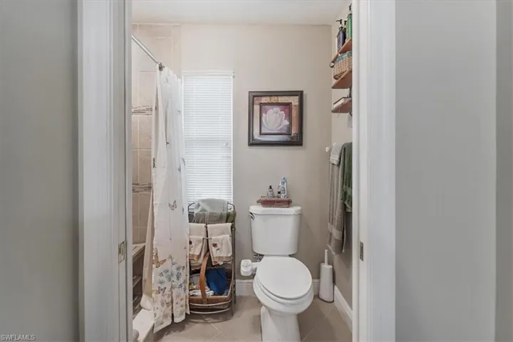Full bathroom with a tile shower and tile patterned floors