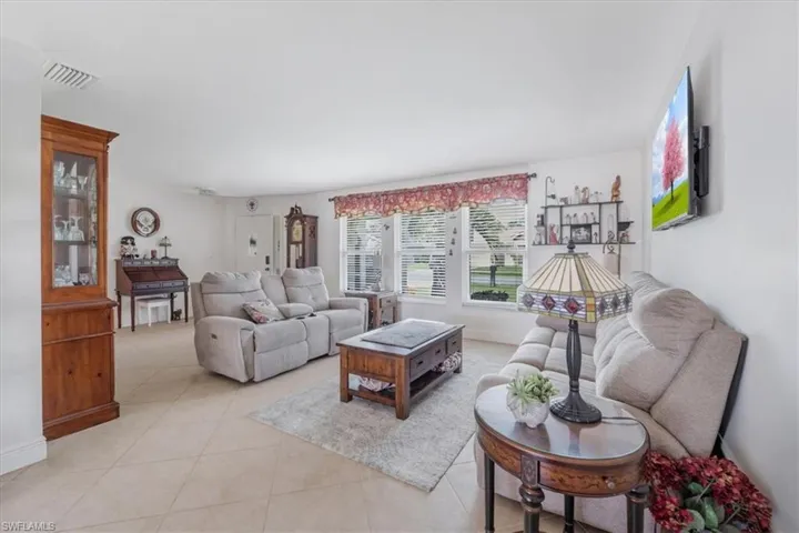 Living area featuring light tile patterned floors and baseboards