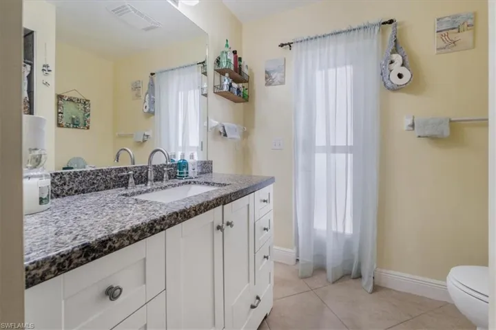 Full bath featuring vanity and tile patterned floors