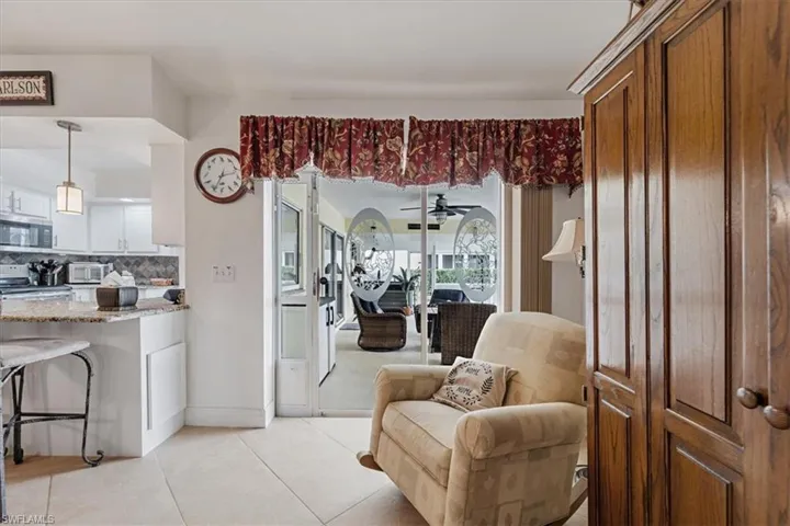 Living room featuring light tile patterned floors and a ceiling fan