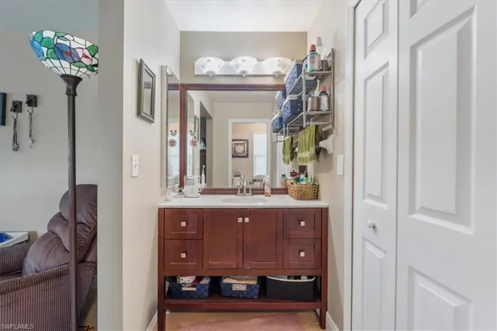 Bathroom with vanity and a closet