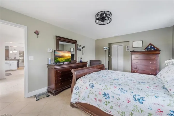 Bedroom with light tile patterned floors and baseboards