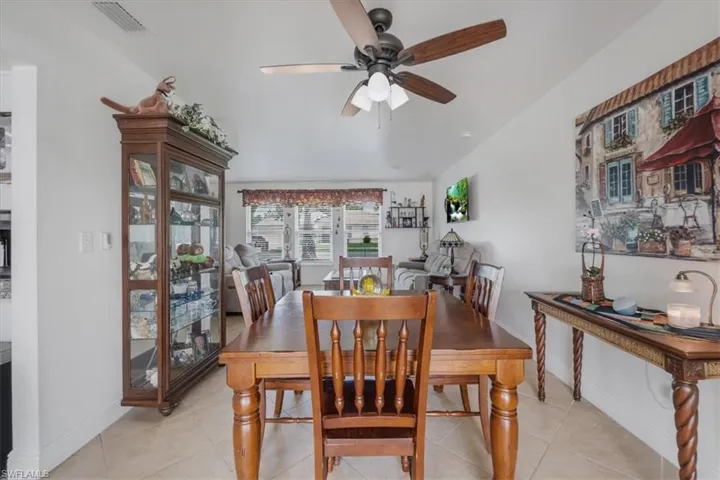 Dining room with a ceiling fan and light tile patterned floors