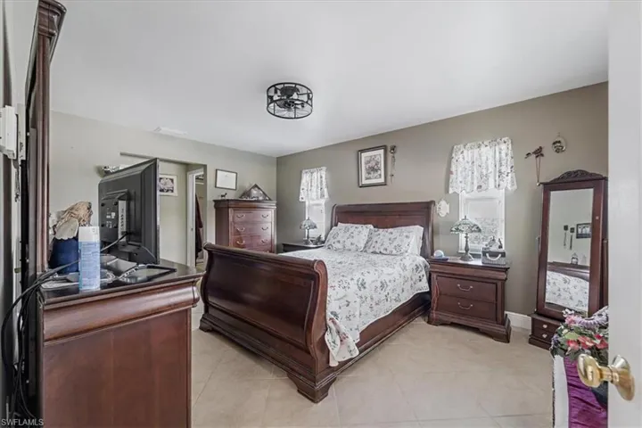 Bedroom with light tile patterned flooring