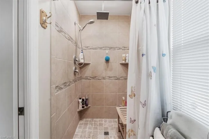Full bathroom with tiled shower