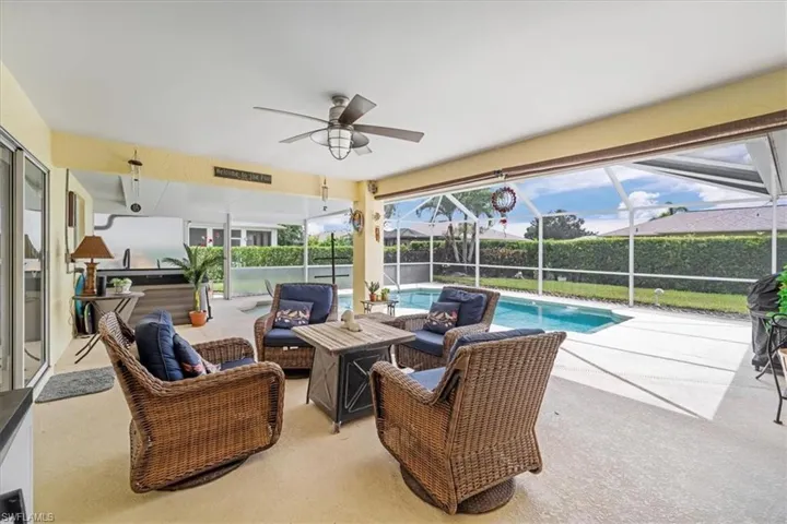 View of patio / terrace with outdoor lounge area, ceiling fan, and glass enclosure