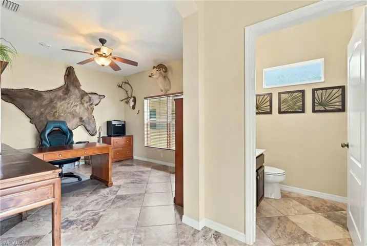 Tile flooring arranged in a diagonal pattern, neutral wall paint, multi-blade ceiling fan, and horizontal window blinds