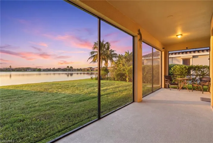 Screened-in patio with concrete flooring, recessed lighting, and water frontage
