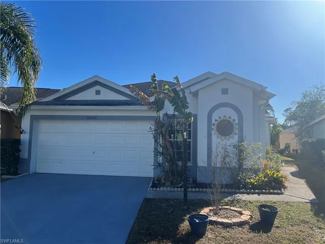 View of front facade featuring stucco siding, concrete driveway, and a garage
