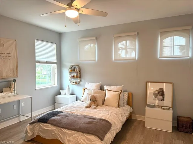 Bedroom featuring wood finished floors and a ceiling fan