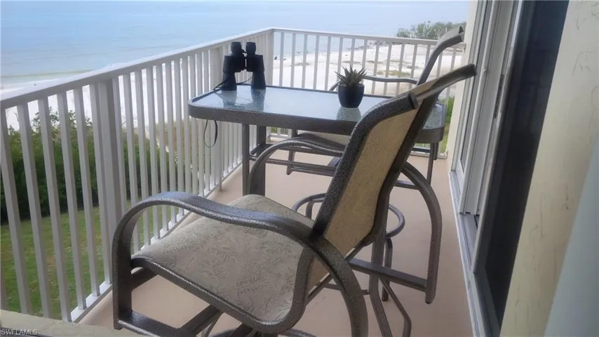 Balcony with a water view and a beach view