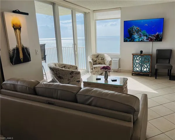 Tiled living room with floor to ceiling windows