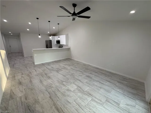 Unfurnished living room featuring recessed lighting, a ceiling fan, and vaulted ceiling