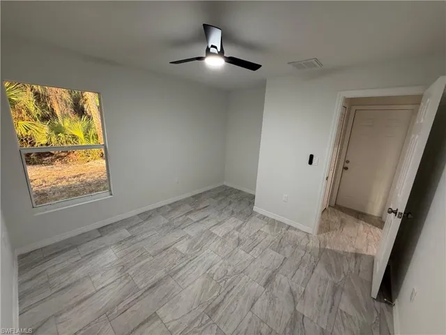 Unfurnished bedroom with ceiling fan and baseboards