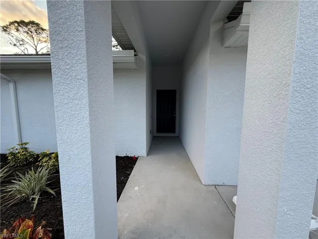 Entrance to property featuring stucco siding