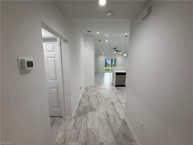 Hall featuring baseboards and recessed lighting