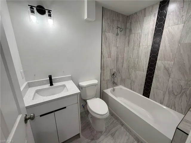 Bathroom featuring vanity and tub / shower combination