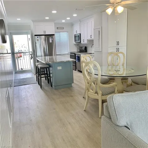 Dining area featuring a ceiling fan, light wood-style flooring, ornamental molding, and recessed lighting