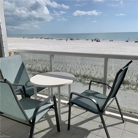 Balcony with view of water and beach