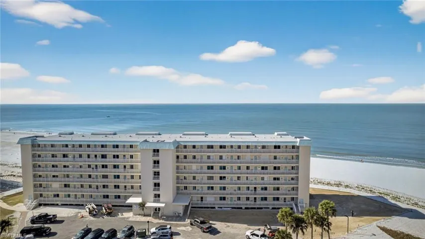 Aerial view of apartment complex and expansive coastline