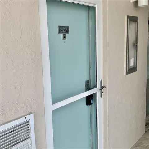 Entrance to property featuring stucco siding