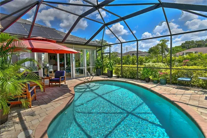 View of pool with a patio area and a screened lanai