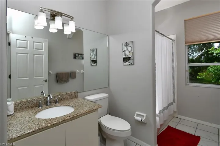 2nd Full bathroom with granite counters & featuring tile floors, toilet, oversized vanity, and shower / bath combo