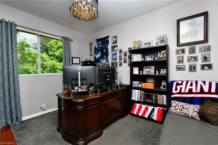BR #2 being used as an office with a chandelier
