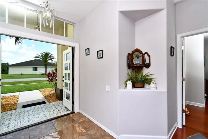 Foyer featuring a notable chandelier and tile flooring