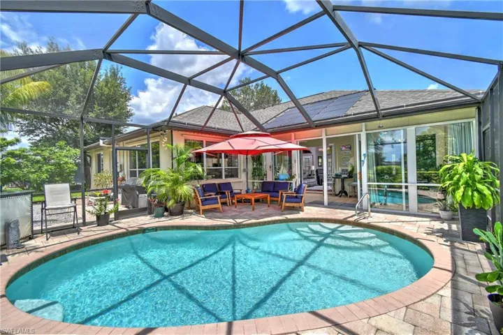 View of pool with an outdoor living space, Sunroom w/glass enclosure leading out onto screened patio/lanai area