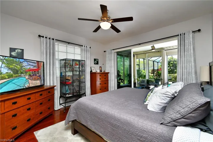 Bedroom featuring ceiling fan, access to Florida Rm, multiple windows, and bamboo engineered wood flooring