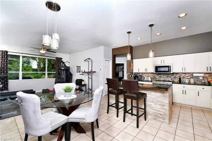 Dining area with ceiling fan and light tile floors