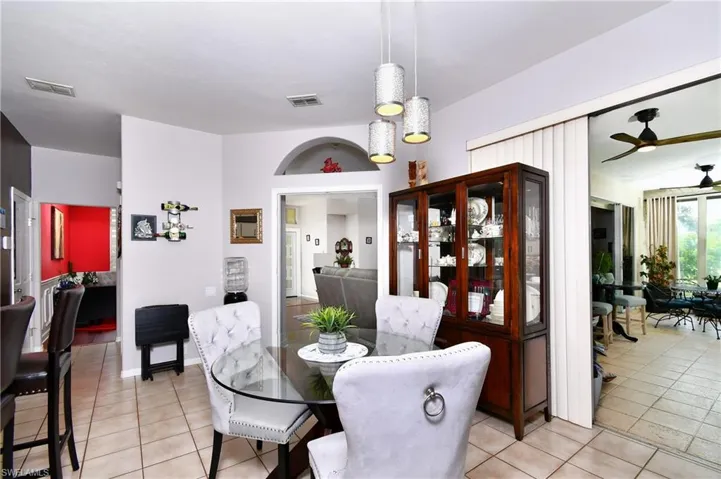 Tiled dining room featuring ceiling fan