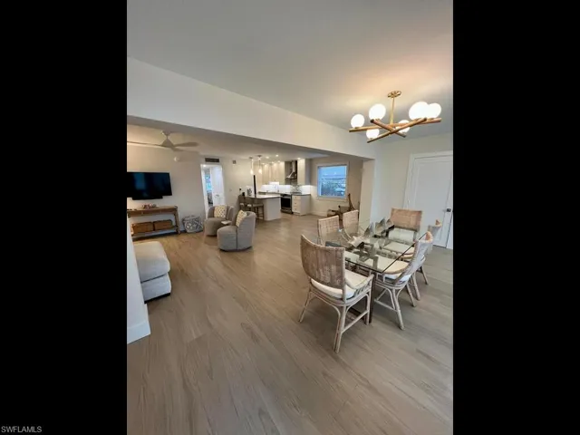 Previously Furnished Dining area with notable chandelier, and a wealth of natural light