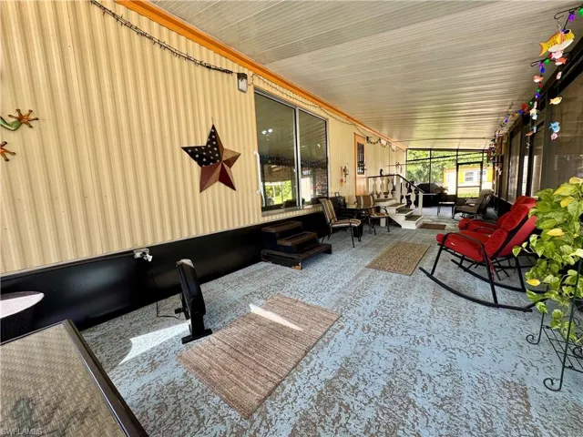 Sunroom / solarium featuring carpet floors