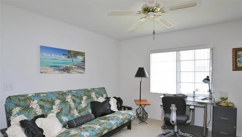 Office with carpet flooring and ceiling fan