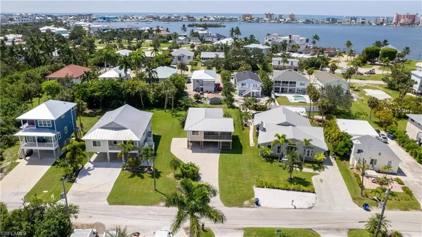 Birds eye view of property with a water view