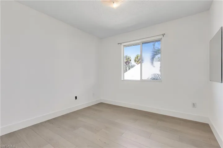 Unfurnished room featuring a textured ceiling and light wood-type flooring